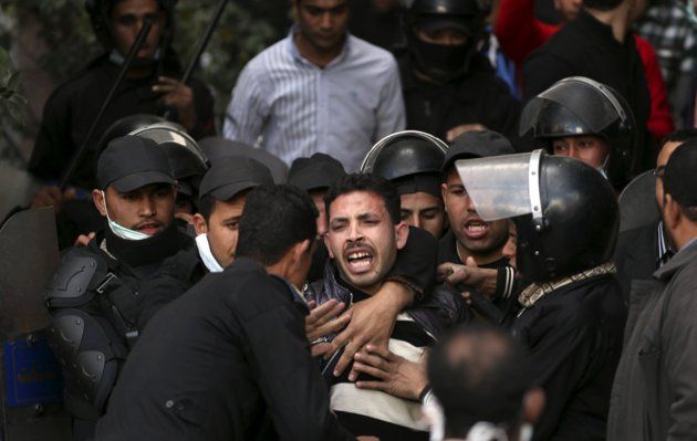egypt riot photo: Egyptian riot police arrest a man during clashes with protesters near Tahrir Square in Cairo, Egypt, Wednesday, Jan. 30, 2013. APKhalilHamra_zpsfdea3d13.jpg